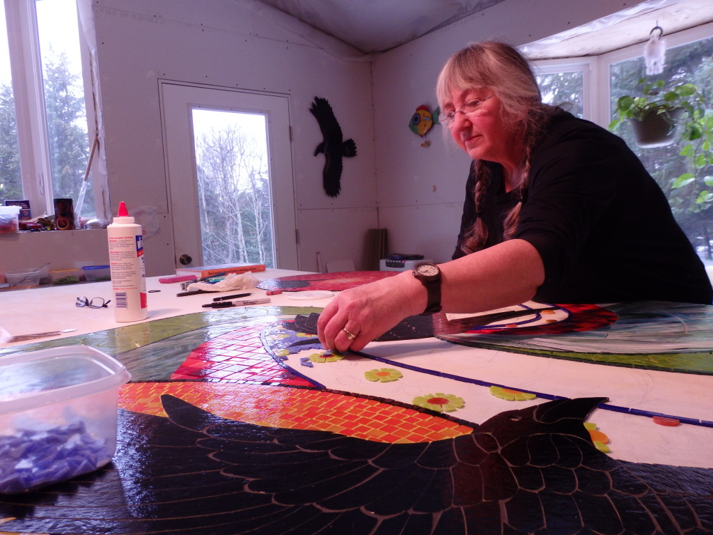 Sharon Svenson works on the "Taking Flight" mosaic. 