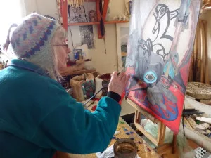 Donna Catotti painting Tlingit regalia for the Fort Seward art project.
