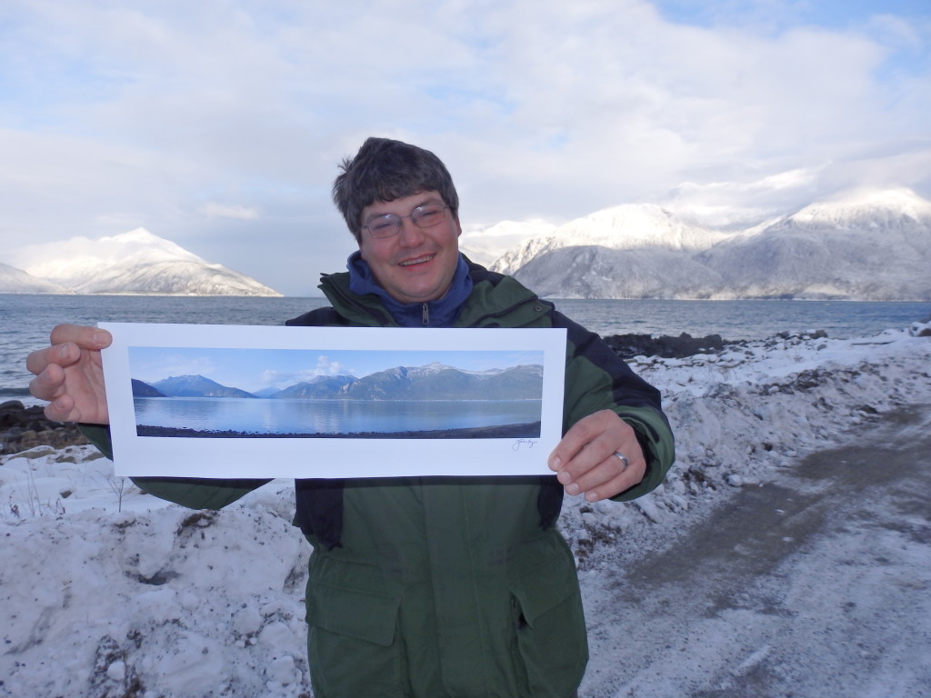John Hagen with a print of his photograph that will be blown up and displayed at Port Chilkoot dock. (Emily Files)