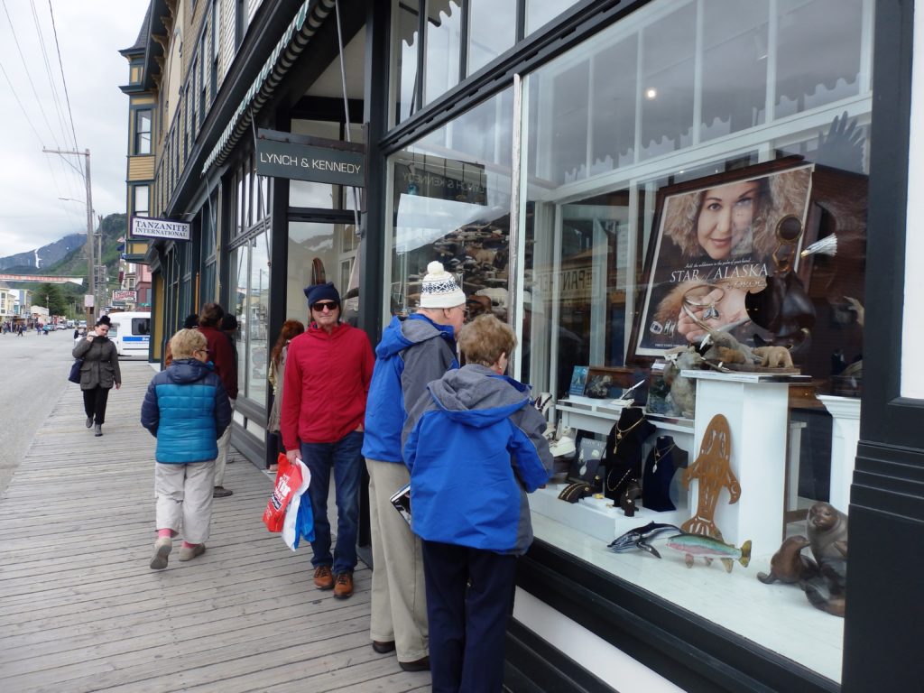 Tourists look in the window of Lynch and Kennedy Dry Goods in May 2016. (Emily Files)