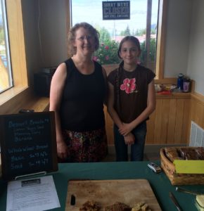 From left, Shannon and Lydia Green are selling homemade bread at Frontier Tradesmen on Wednesdays. (Jillian Rogers)